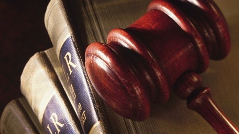 A wooden gavel on top of several legal books