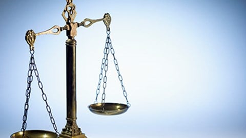 Legal scales of justice on blue gray background
