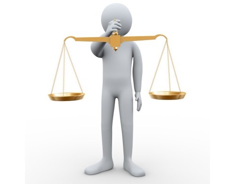 Person Holding Golden Scales of Justice