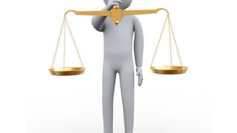 Person Holding Golden Scales of Justice