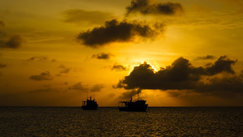 Fishing boats out at sunset in the Caribbean