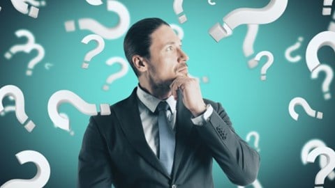Businessman pondering surrounded by question marks