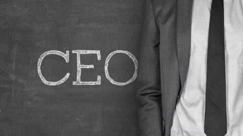 CEO Written On Chalkboard Next To Businessman