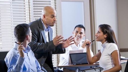 Four Business People Meeting In A Board Room