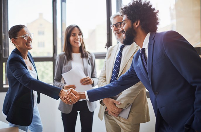Business colleagues shaking hands in a meeting