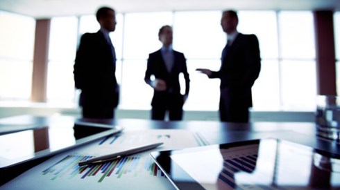 Silhouettes of three businessmen at a planning meeting