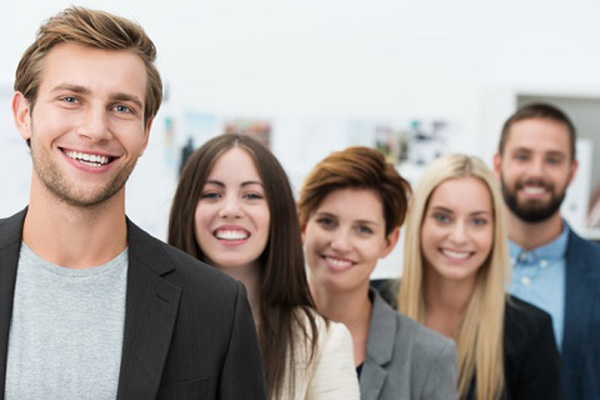 Five young business professionals smiling