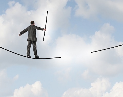 A businessman in the clouds is walking on a tightrope using a balancing pole and will approach a section that has disappeared