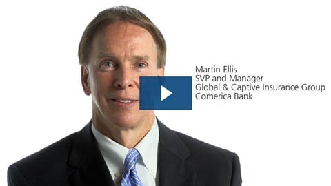 Headshot of Martin Ellis with a blue play button on top.