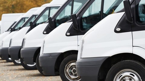 White commercial delivery vans parked in a row