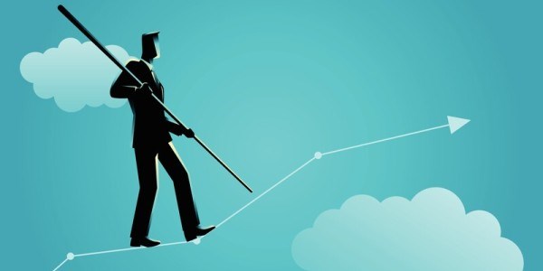 Businessman walking a tightrope up arrow