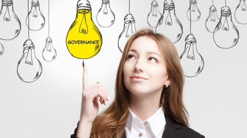Business Woman Pointing At A Lightbulb That Says Governance