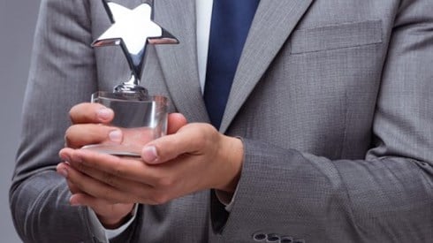 Businessman holding star trophy