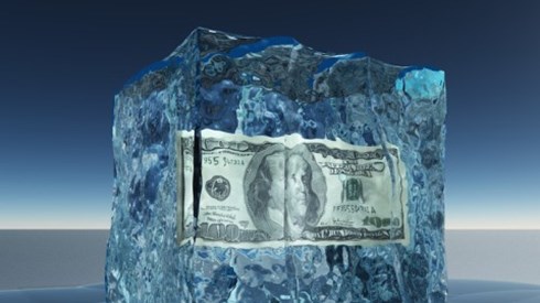 A 100 dollar bill frozen in a block of ice