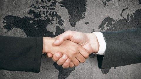 Handshake In Front Of Flat World Map