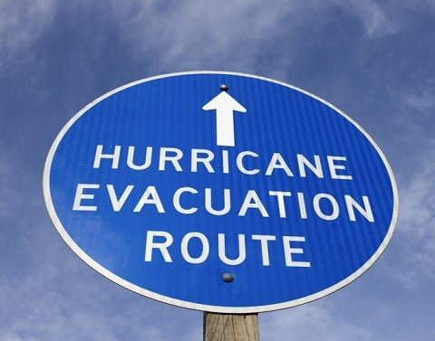 Image of blue "Hurricane Evacuation Route" sign against blue sky