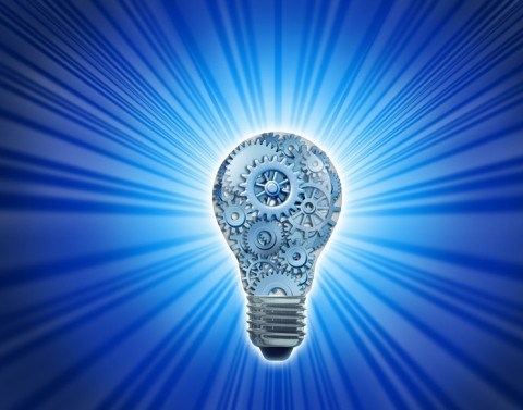 A light bulb filled with different sizes of gears emanates blue light