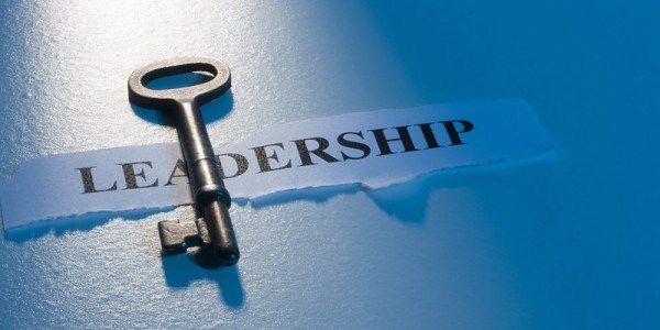 A skeleton key lying on top of the word LEADERSHIP