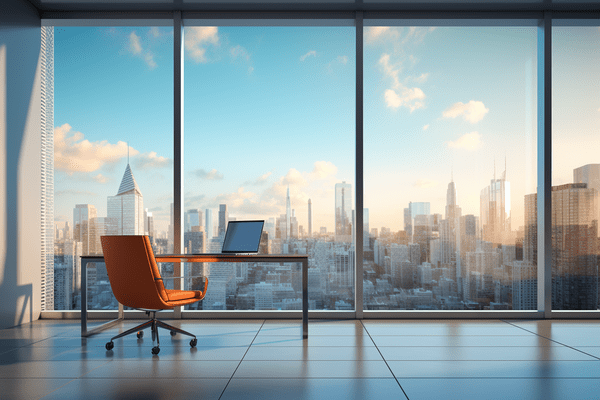 Empty Executive Chair at a Desk with a Monitor Looks Out a Bank of Windows at a City Skyline