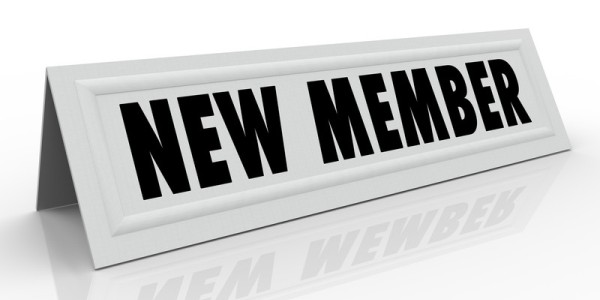 New member table card sign reflecting on shiny white surface
