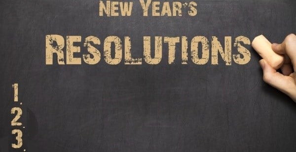 A hand writing on a New Year´s Resolutions list of items 1, 2 and 3