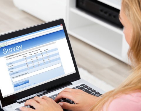 A woman taking an online survey on a laptop