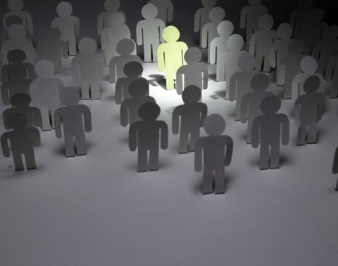 People figures In gray with one standing out in light green