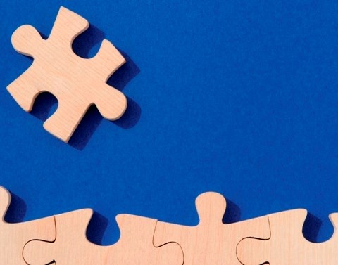 Wooden puzzle pieces on a blue background