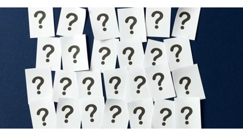 Four rows of sheets of paper with a question mark printed on each