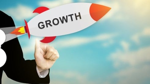 Business person selecting and launching a rocket with the word growth on it