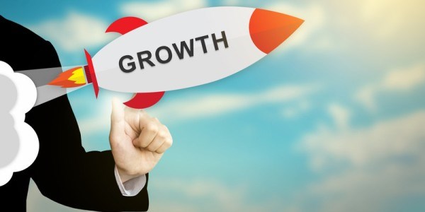Business person selecting and launching a rocket with the word growth on it