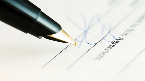 Pen next to a signature on a legal document  