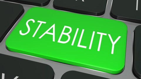 The word Stability printed in white letters on a green key on a gray computer keyboard with other black keys surrounding it