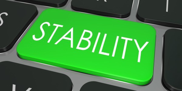 The word Stability printed in white letters on a green key on a gray computer keyboard with other black keys surrounding it