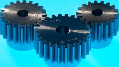 Three mechanical gears with blue background