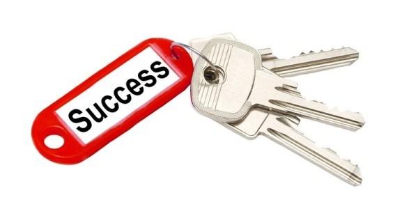 Three keys with a red keychain tag that says Success
