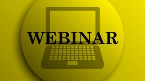 Yellow pinback button with a laptop silhouette in the background and the word WEBINAR in the foreground