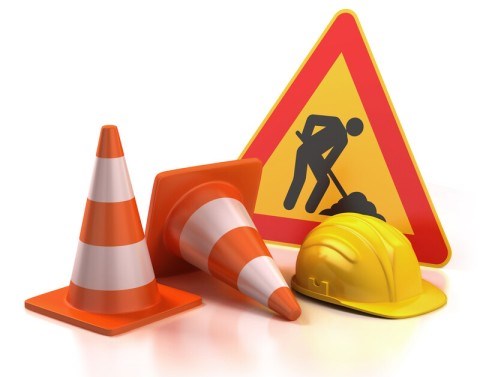 Construction sign, cones and hard hat