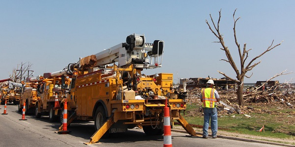 Repair Crew And Trucks Viewing Tornado Damage