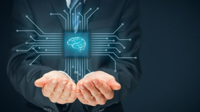 Businessman holding an enlarged microchip with a human brain