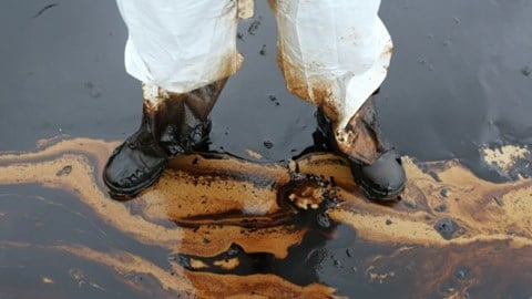 Man Standing in Crude Oil Spill