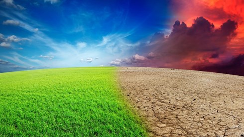 Half of earth´s horizon has blue sky white clouds and green fields while the other half has dark orange sky dry parched land