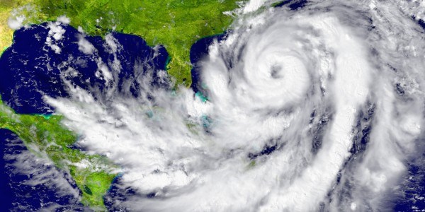 Hurricane extending from Caribbean Sea to Atlantic Ocean with the eye off the eastern United States just above Florida