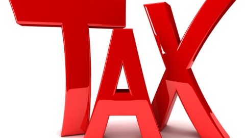The word TAX in red glossy letters