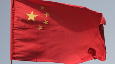 The Chinese flag is red and in upper left corner has four small stars in a semicircle around one large star
