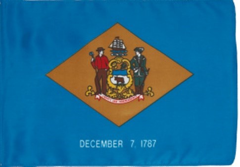 The Delaware flag with a gold color diamond in the middle of light blue material with white December 7, 1787 at bottom