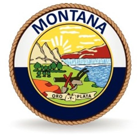 A rope circles the word MONTANA and the state seal which is a sunrise shining over landscape and farming and mining tools