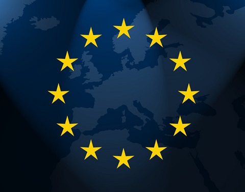 12 yellow stars in a circle on top of a map of the European continent on a dark blue wavy material