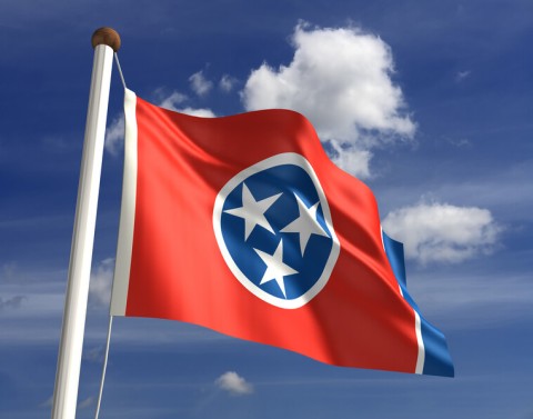 Tennessee State Flag with Blue Sky and Clouds in Background