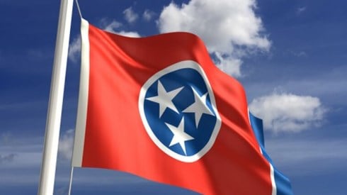 Tennessee State Flag with Blue Sky and Clouds in Background